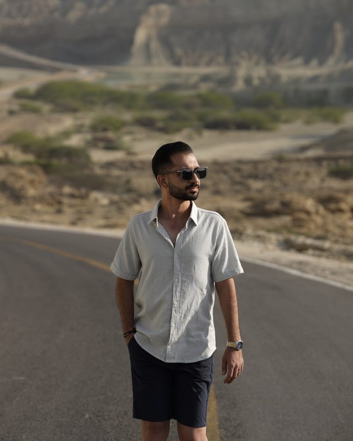 Mehdi Sadeghi standing on a winding desert road
